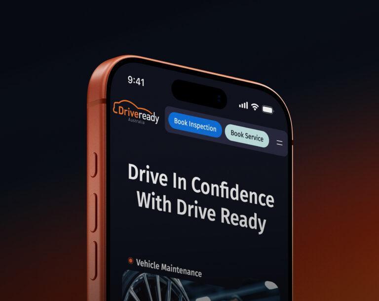 Close up of a mobile phone with the home page design of the Drive Ready Australia website.