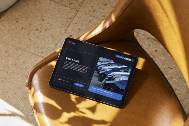 A tablet lying on a leather sofa chair with the website for Drive Ready Australia displayed on screen.