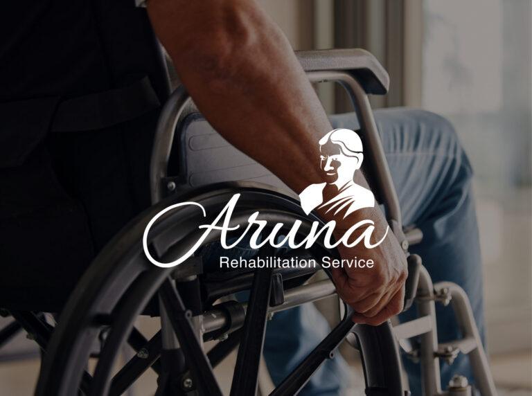 The Aruna Rehabilitation Service logo placed in front of a man in a wheelchair.