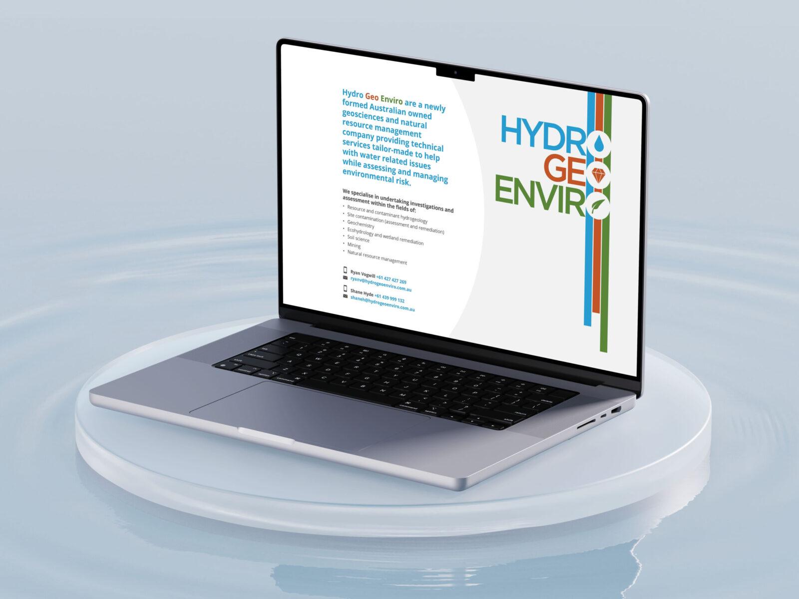 A mockup of a laptop floating on water, with the screen displaying the Hydro Geo Enviro website home page design.