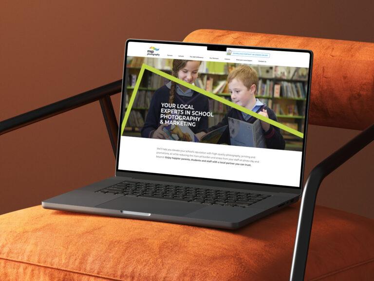 A laptop lies on a cushioned chair, showcasing the website design for MSP Photography.